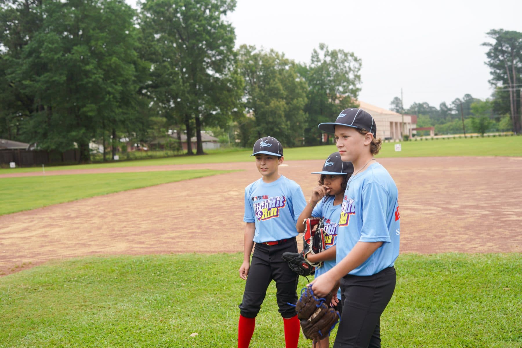 Young players in their gear standing on Justice Field.