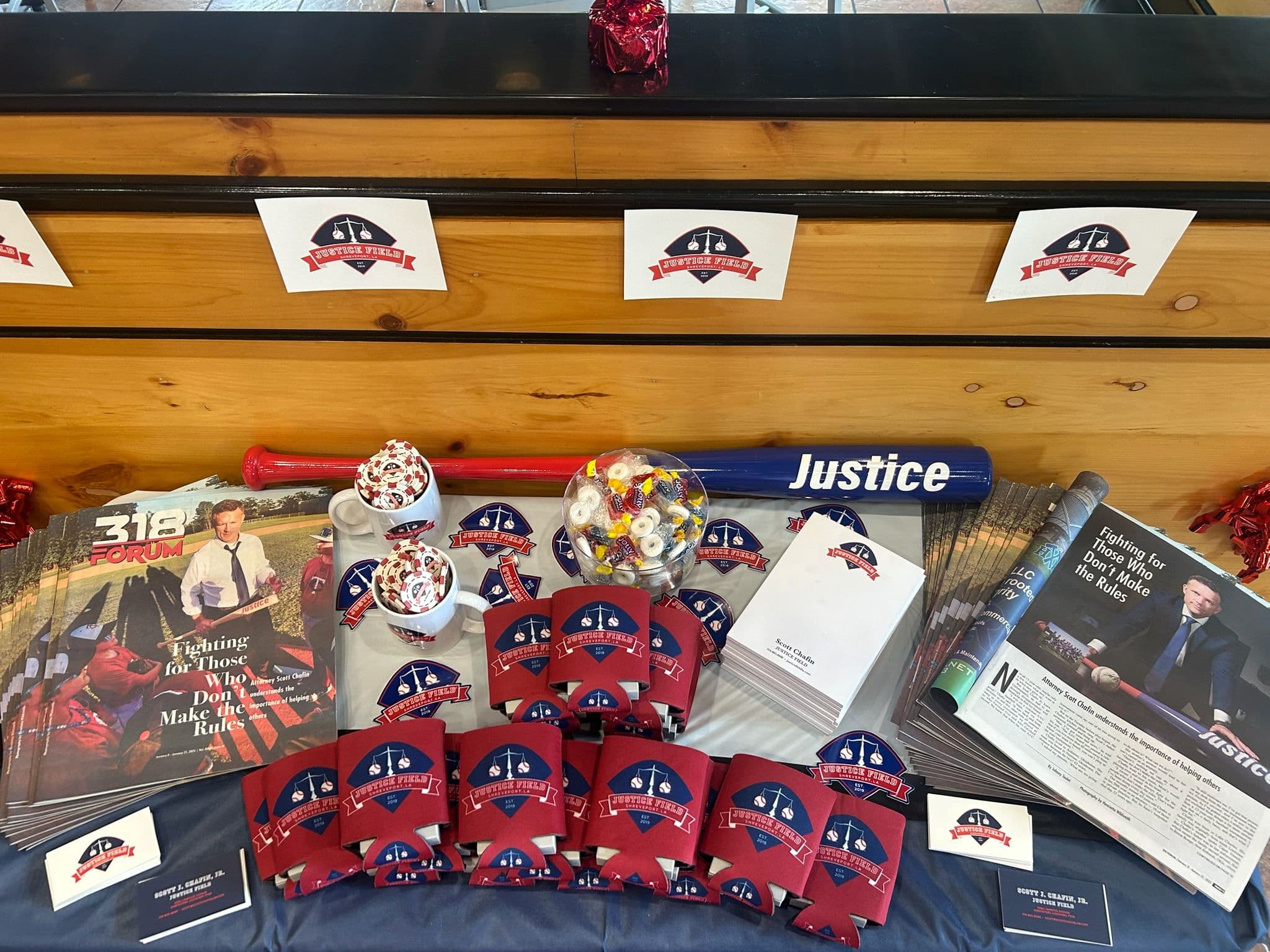 Magazines, poker chips, cozies, and other giveaways on a table.