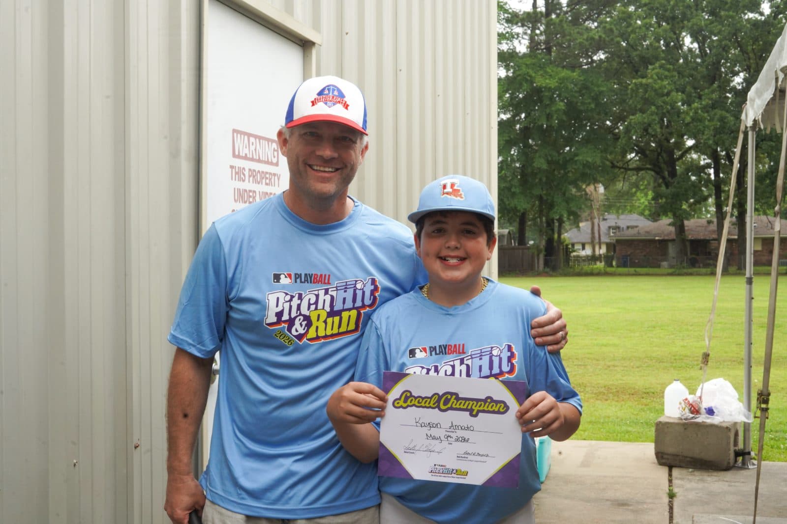 Scott Chafin with a young Pitch, Hit & Run local champion holding his certificate.